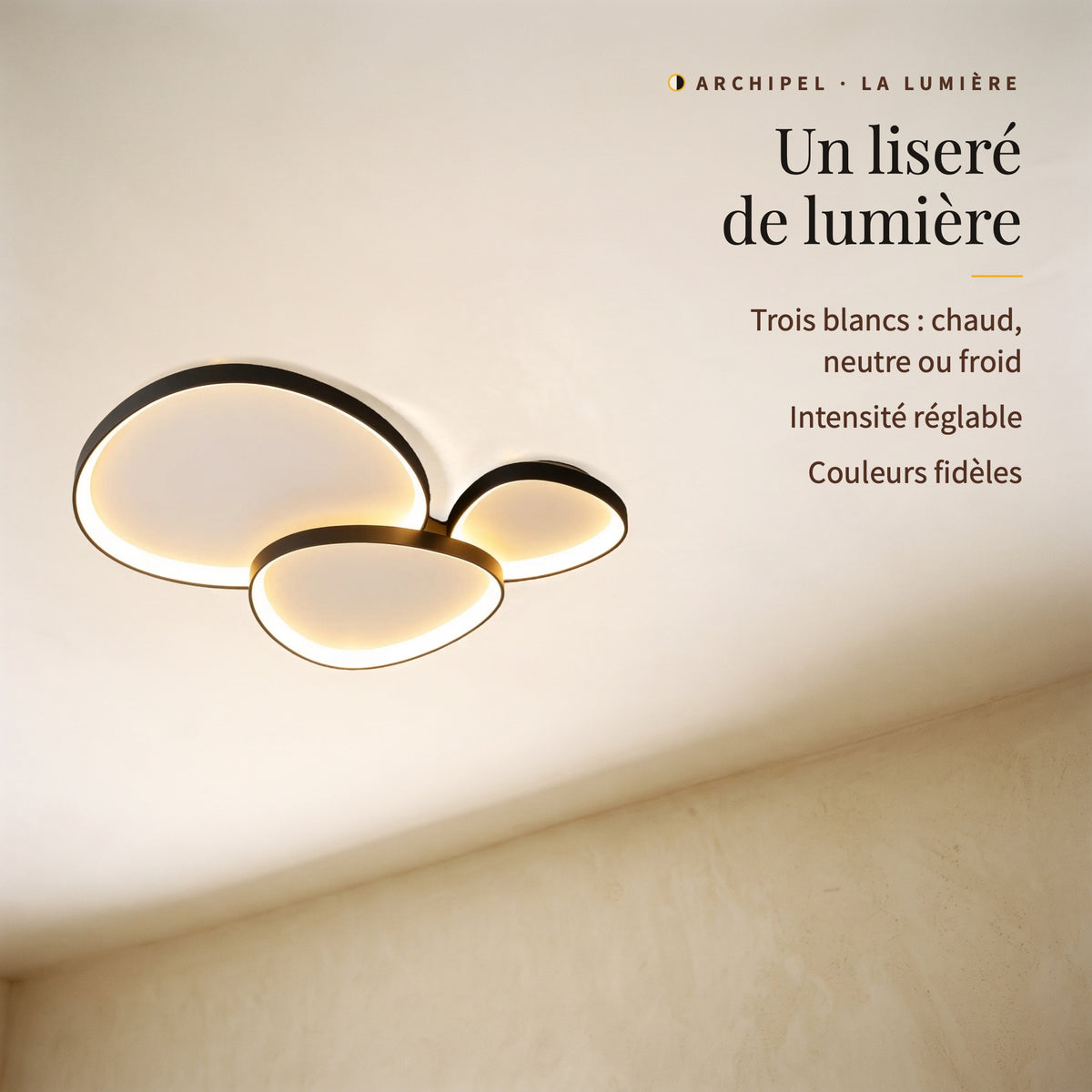 Archipel, trois galets allumés vus de biais : liseré de lumière, trois blancs, intensité réglable, couleurs fidèles